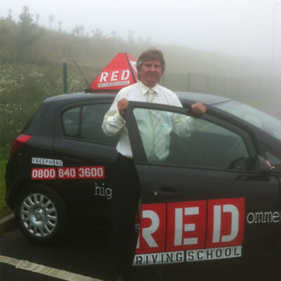 Anthony Fuller with Red Driving school car