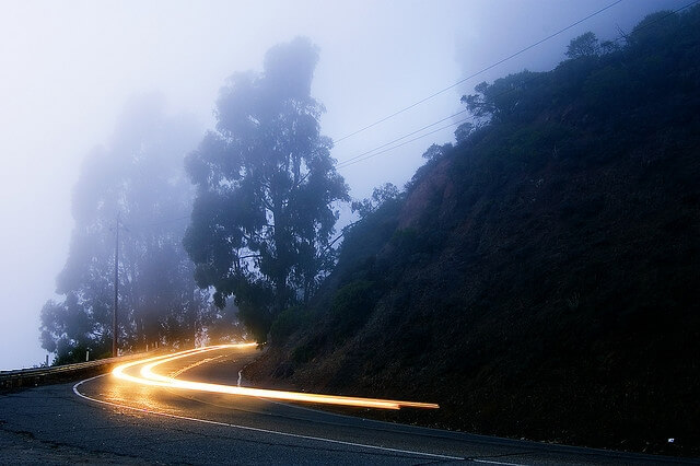 Car headlights on long exposure round a bend
