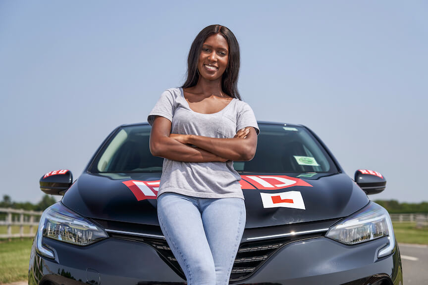 Woman resting on car